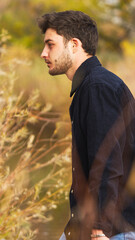 A young man walking in the autumn 