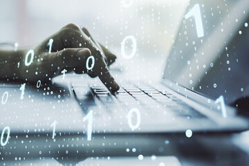 Double exposure of creative abstract binary code hologram and hands typing on laptop on background. Database and programming concept
