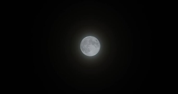 image of full moon on misty night. An image of the moon filling the screen. Detailed and sharp moon view. 6K Shooting.