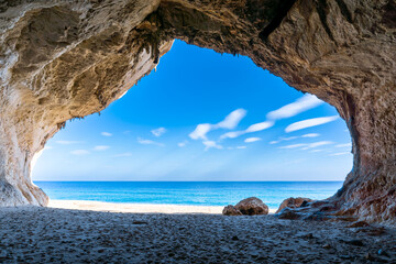 view out of one of the many seaside caves at the beach of Cala Luna in Sardinia - obrazy, fototapety, plakaty