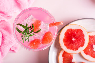 Pink cocktail with rosemary in glasses on the table. Pink food concept. Top view. Closeup