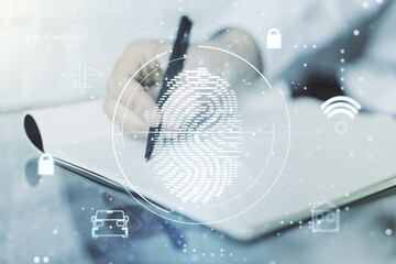 Multi exposure of creative fingerprint hologram with man hand writing in notebook on background, personal biometric data concept - Powered by Adobe