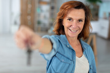 portrait of a mature woman holding forwards a blurred object