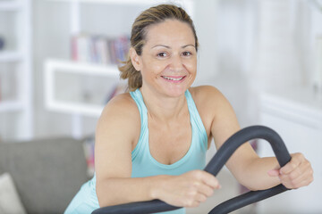Fototapeta na wymiar mature woman exercising on step machine