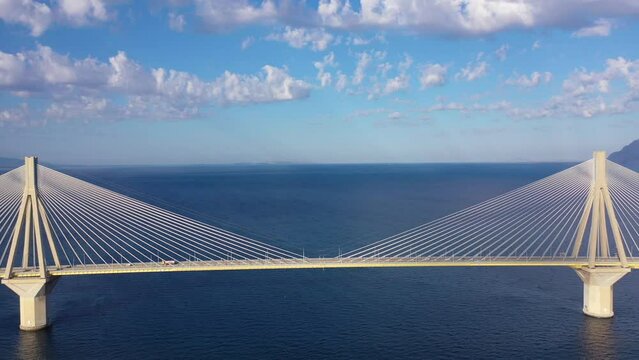 Aerial drone video of famous state of the art modern cable strait bridge of Rio Antirio crossing corinthian gulf from Peloponnese seaside city of Rio to Antirio - mainland Greece