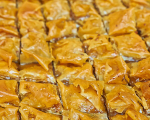 Freshly baked Βaklava, delicious oriental desert with nuts and honey syrup. Sweet background.