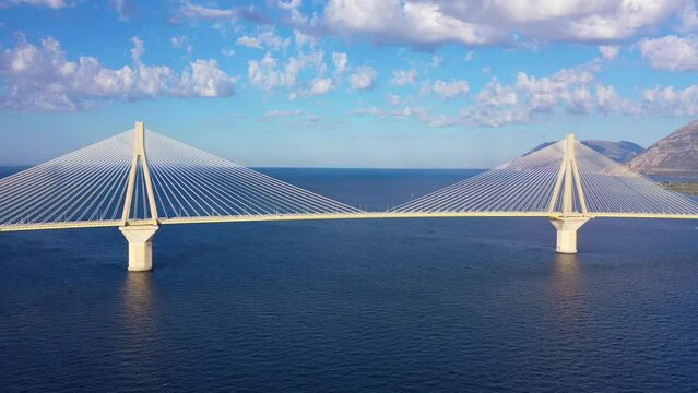 Aerial drone video of famous state of the art modern cable strait bridge of Rio Antirio crossing corinthian gulf from Peloponnese seaside city of Rio to Antirio - mainland Greece