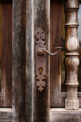 Antique wooden ornamental door with elegant iron handle