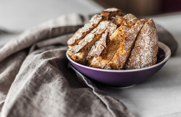 Slices of freshly baked bread in a ceramic bowl.