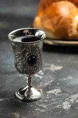 Obraz premium Homemade braided challah shabbat wine, Traditional Jewish Shabbat ritual. Shabbat or Shabath concept. vertical image. top view. place for text
