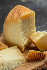 gruyere hard yellow cheese. a traditional Swiss hard yellow cheese without holes, with a dark crust and a pleasant floral and nutty aroma, place for text, top view