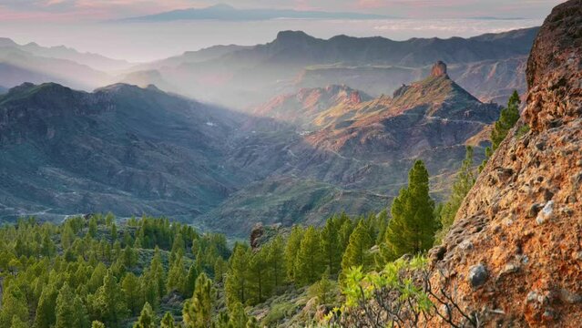 Sunset view from Roque Nublo over Gran Canaria, Canary islands, Spain. Tenerife island visible in the background. Gimbal shot, 4K