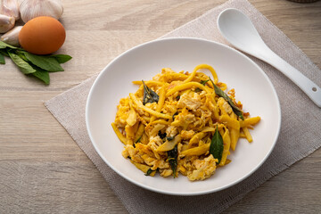 Stir Fried Bamboo Shoot with Egg and basil leave in white plate