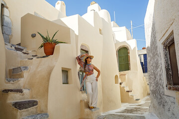 Young woman travels around the island of Santorini.