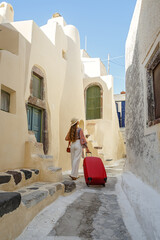Young woman with a red suitcase travels