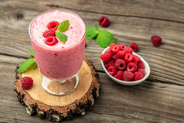 raspberries smoothie milkshake or yogurt in glass jar with berries. Yogurt cocktail. place for text, top view