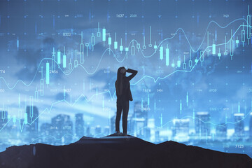 Back view of backlit woman looking at glowing business forex chart hologram and grid on blurry night city background. Trade, stock, finance and invest concept. Double exposure.