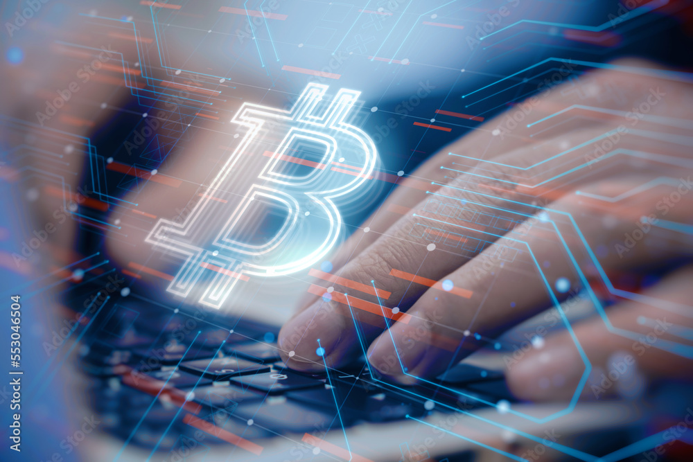 Poster close up of male hands using laptop keyboard with glowing bitcoin hologram on blurry desktop backgro