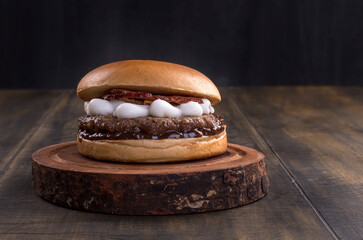 Smash burger with catupiry cheese and bacon, barbecue sauce, on a delicious brioche bun