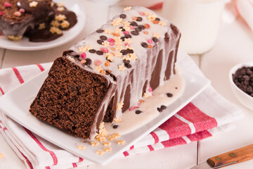Sponge cake with white frosting and sugars.