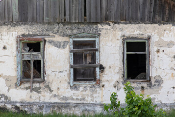 An old house with boarded up windows.