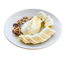 banana, honey, walnuts and cream on a plate, isolated on white background, clipping path.