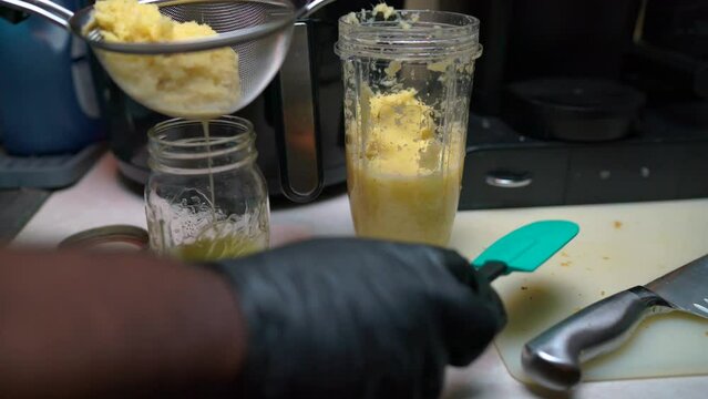 Fresh blended ginger for ginger shots squeezed into mason jar