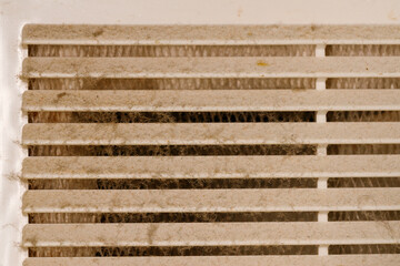 Very dirty and dusty white plastic ventilation grill. Ventilation shaft in the apartment. dirty air filter. House cleaning concept