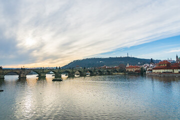 Prague cityscape - winter view of Vltava river, tourist boat, Charles Bridge, old town in Prague, Czech Republic. Taken in the city center of Prague.