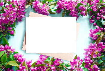 Flowering branches and petals on a blue background and envelope.