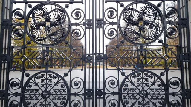 Wrought iron gate at the entrance to Frogner park in Oslo Norway. Intricate pattern made of black metal with curved ornaments.