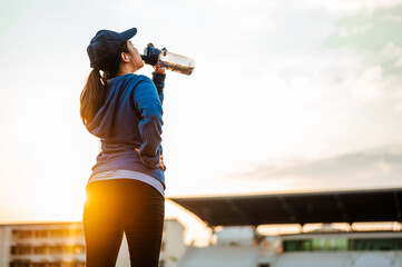 Stop resting and Drink whey protein rest after running jogging on the running track around in the...
