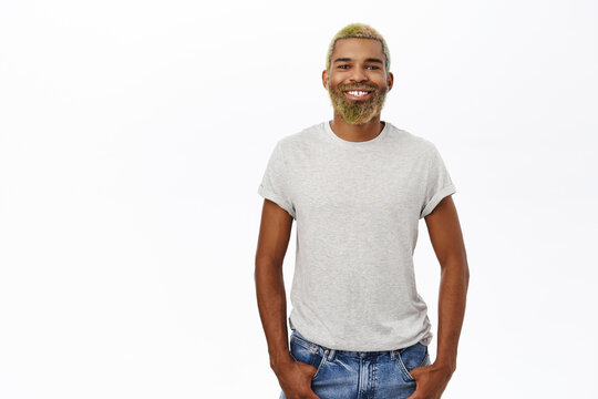 Smiling Hipster Guy With Yellow Beard And Hair, Looking Happy And Confident, Wearing Grey Shirt, Studio Background