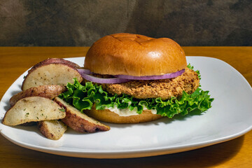 chicken fillet sandwich  with a siode of potato wedges
