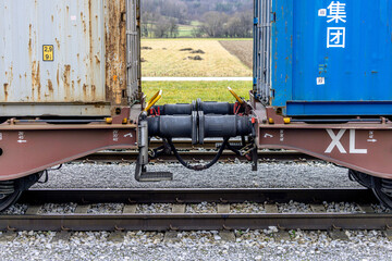 Close up detail of iron connection of two train wagons. Railway car coupler and train buffers....