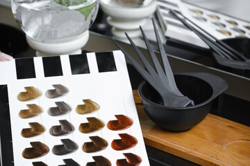 Hair color samples, hair palette and working tools in hairdressing salon. Hairdresser Working place...