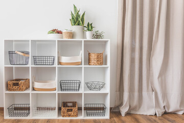 White stylish shelf in scandi style. Storage baskets. Japanese method organizer boxes set. Closet...
