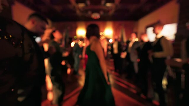 Blurry: People are dancing and partying at a Christmas event