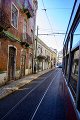 Fototapeta na wymiar Lisbon, Portugal, November 6, 2022. Public transportation in Lisbon, touristic route Alfama old city with cable tram line 28, famous touristic attraction