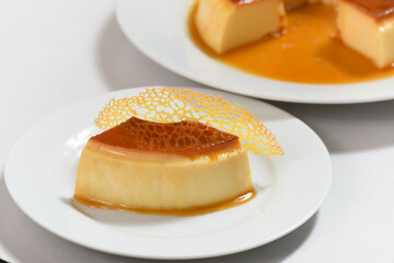 guomert pudding with yellow tulie garnish on white background
