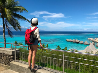 Woman tourist relaxe on Bora Bora island, Polynesia. Girl standing on viewpoint enjoys beautiful...