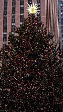 NEW YORK, NY, USA - DECEMBER 10, 2022: Rockefeller Center Christmas tree in New York City in December during holiday season with beautiful lights in vertical format