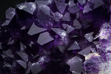 amethyst macro detail texture background. close-up raw rough unpolished semi-precious gemstone...