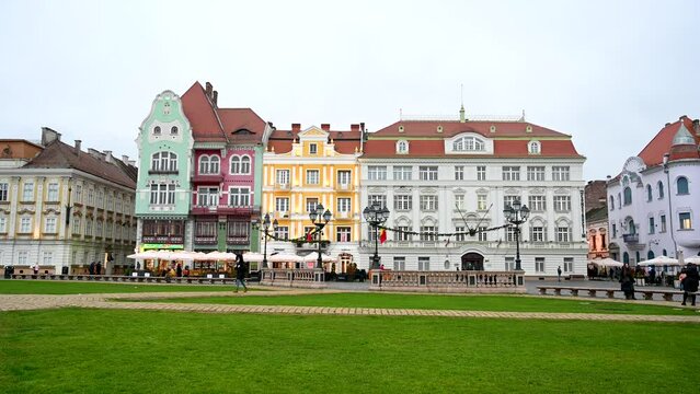 Colorful Buildings on square in city centre. People walking on Union Square.