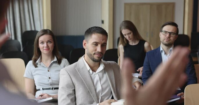 Seminar participant asks questions, talks, communicates to speaker during group workshop in office conference hall, take part in educational training for corporate staff member to get new information