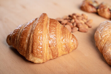 bread and croissants Aromatic almonds laying on wooden floor with an empty floor in a vintage tone style

