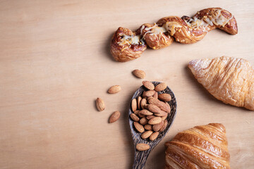 Topview shot of almonds with big slices of bread on dark wooden background concept of health care
