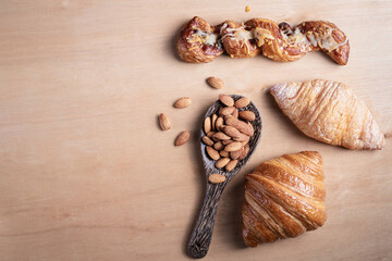 Topview shot of almonds with big slices of bread on dark wooden background concept of health care
