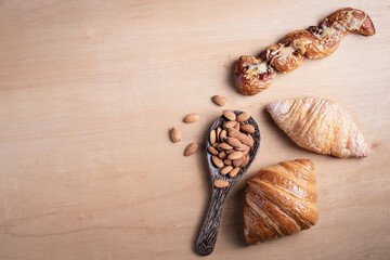 Topview shot of almonds with big slices of bread on dark wooden background concept of health care
