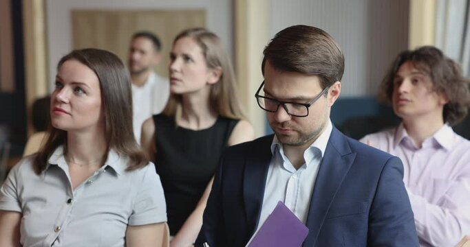 Seminar participant listen to speaker, noting, jotting information take part in group training with mates, applauding express gratitude to business coach showing appreciation for received knowledge